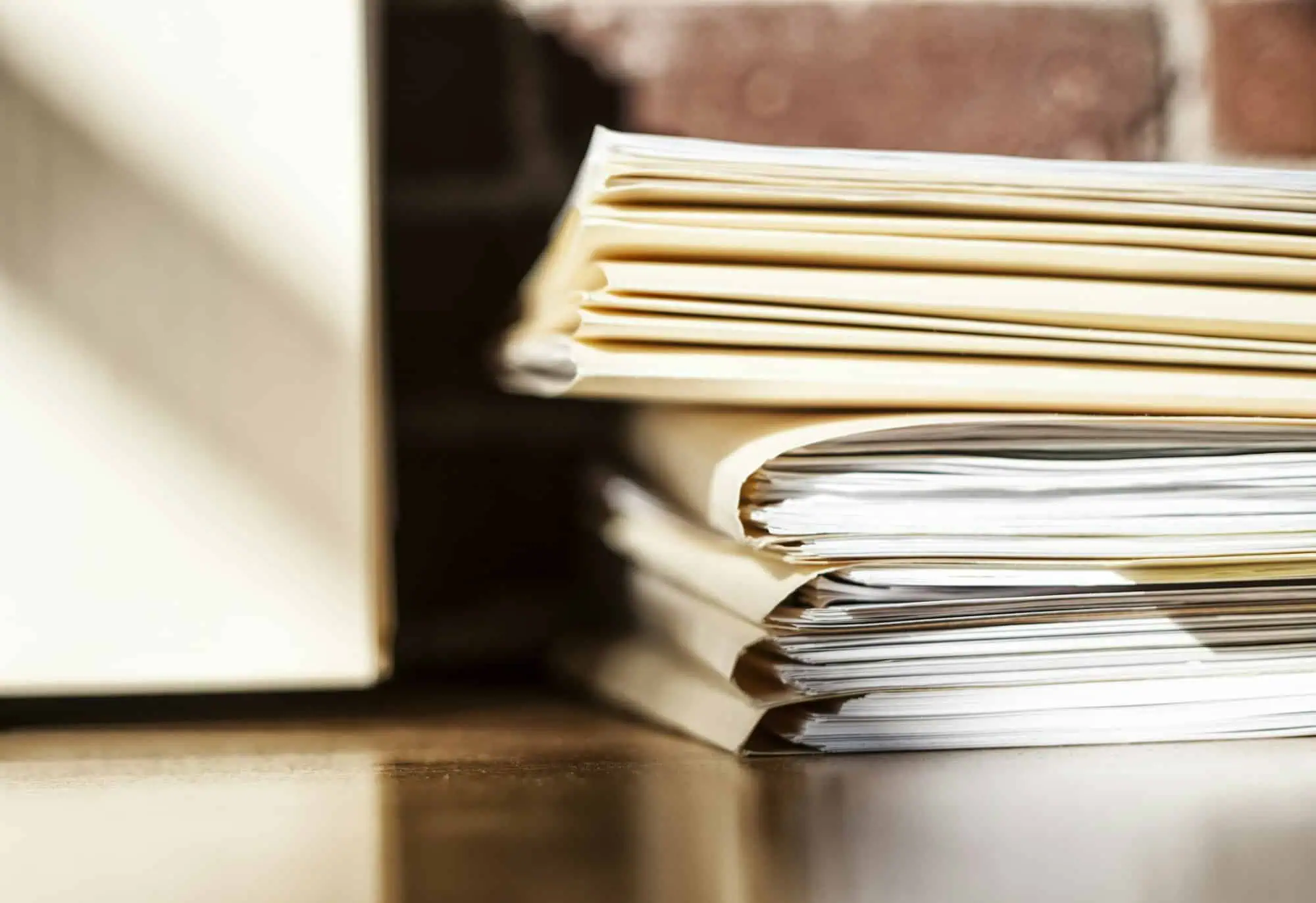 Close-up of files and file folders on a desk top in an office.