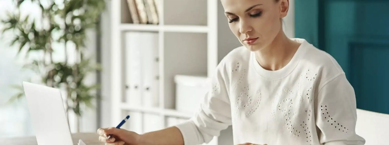 Concentrated woman budgeting at office
