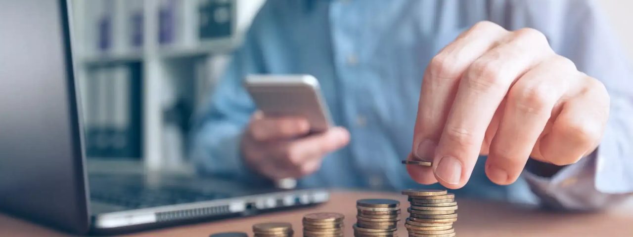 Finances and budgeting, businessman stacking coins