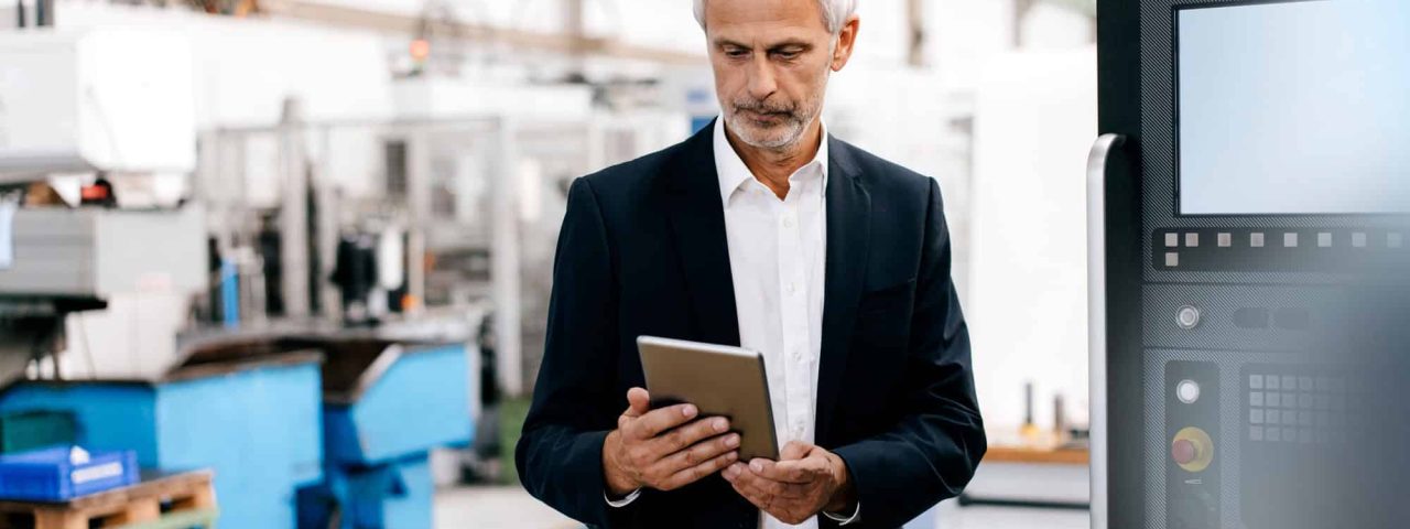 Manager using digital tablet in high tech company