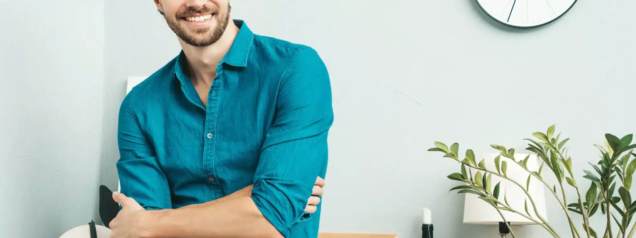 Portrait of young handsome man posing in the office