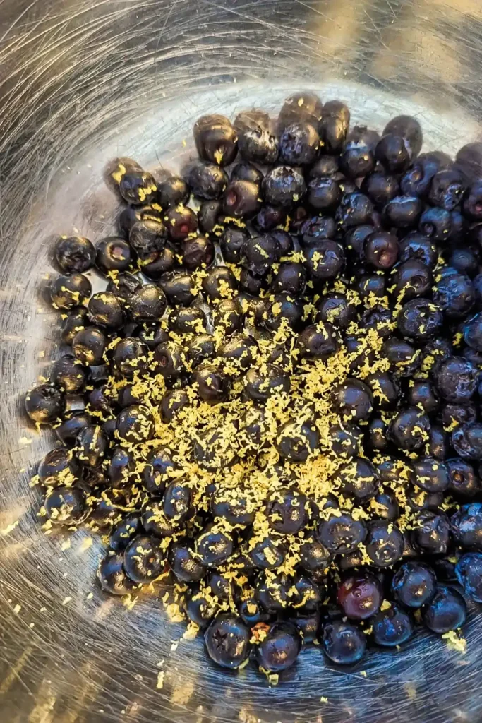adding lemon zest to blueberries