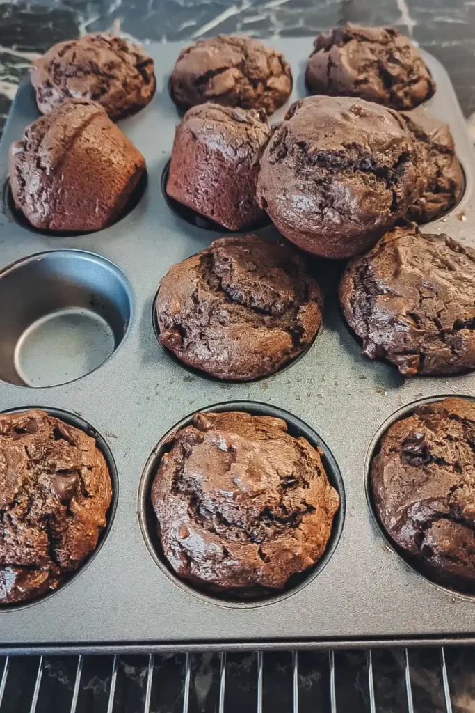 removing the chocolate orange blossom baked muffins from the pan