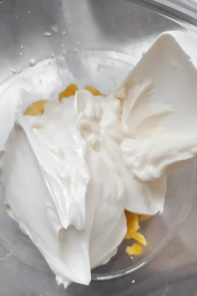adding mayonnaise to hard boiled egg yolks
