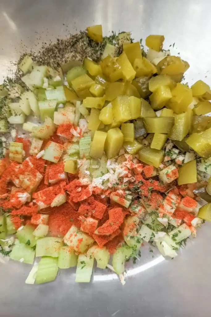chopped vegetables and dill pickles with spices for potato salad