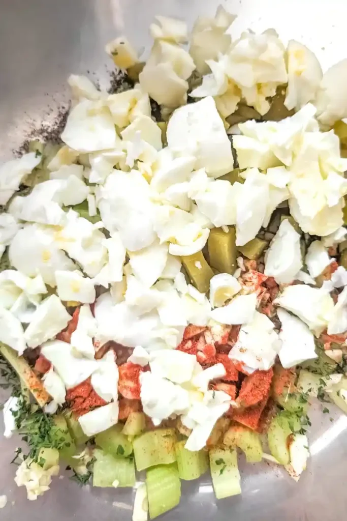adding chopped hard boiled egg whites to potato salad
