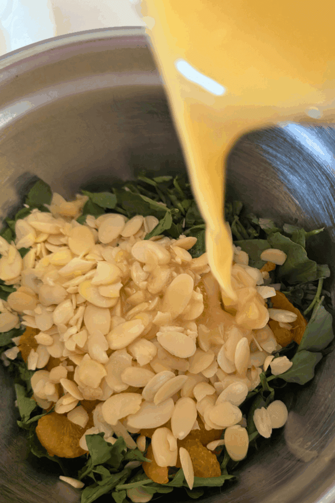 adding dressing the salad with nuts
