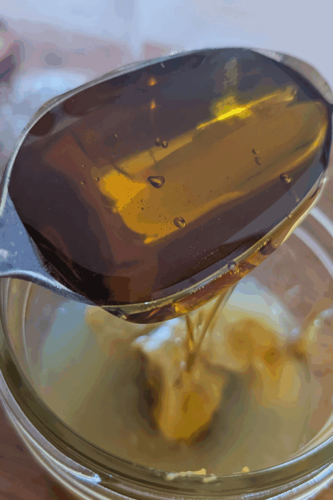 adding honey to dressing
