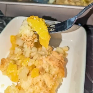 recipe care image of peach cobber peach slice on fork tine