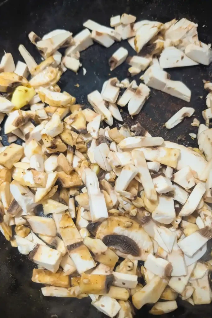 adding chopped mushroom to hot pan