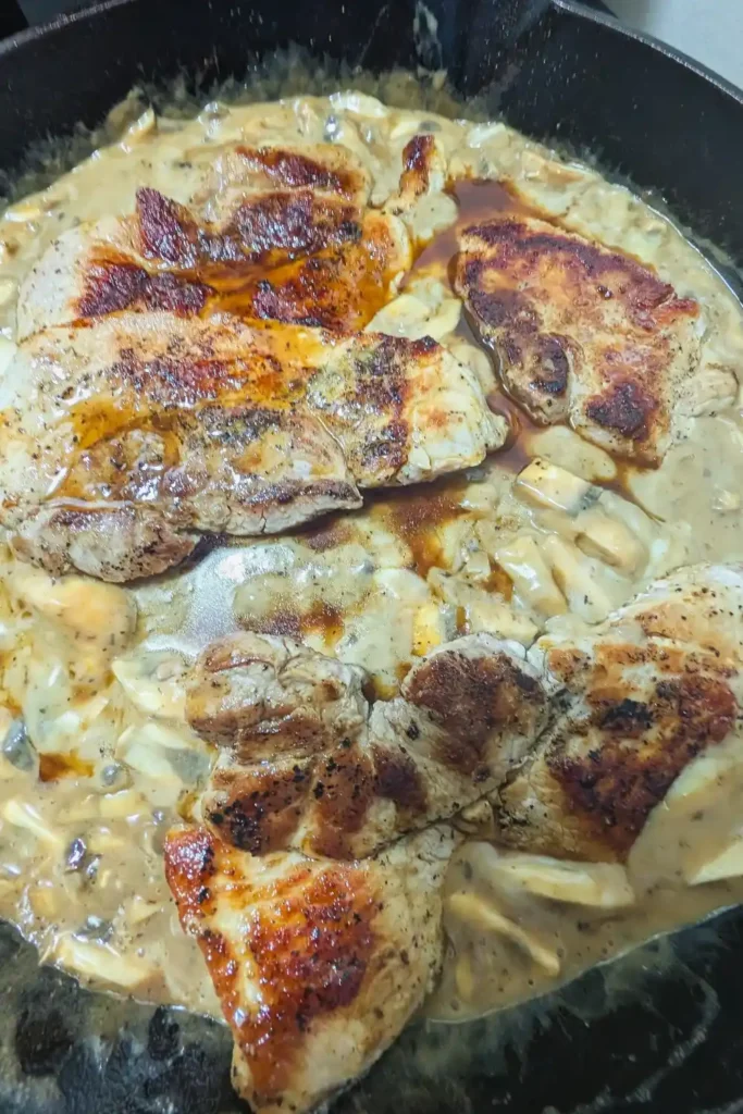 adding pork chops back to mushroom sauce in pan