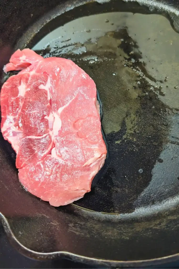 pork loin in cast iron skillet with oil