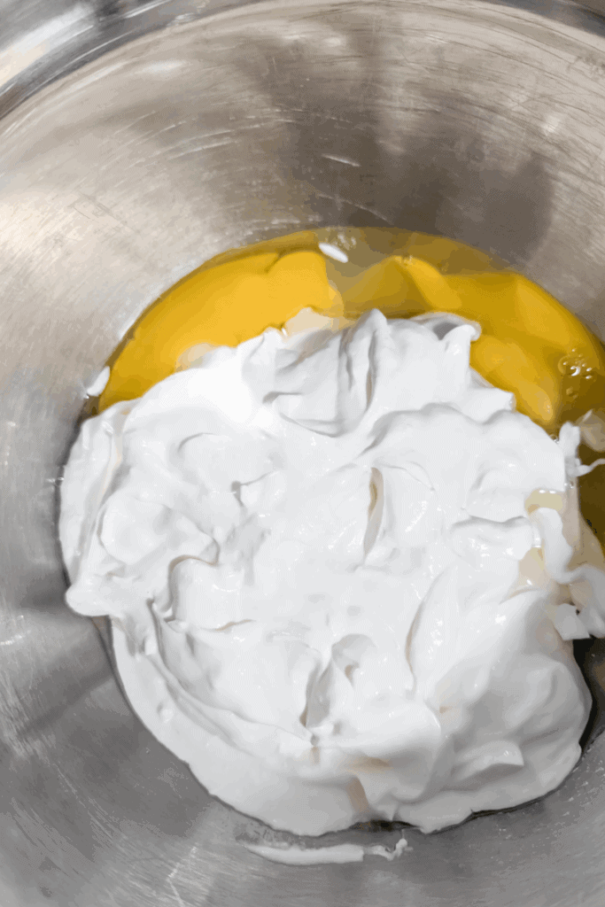 mixing egg and sour cream