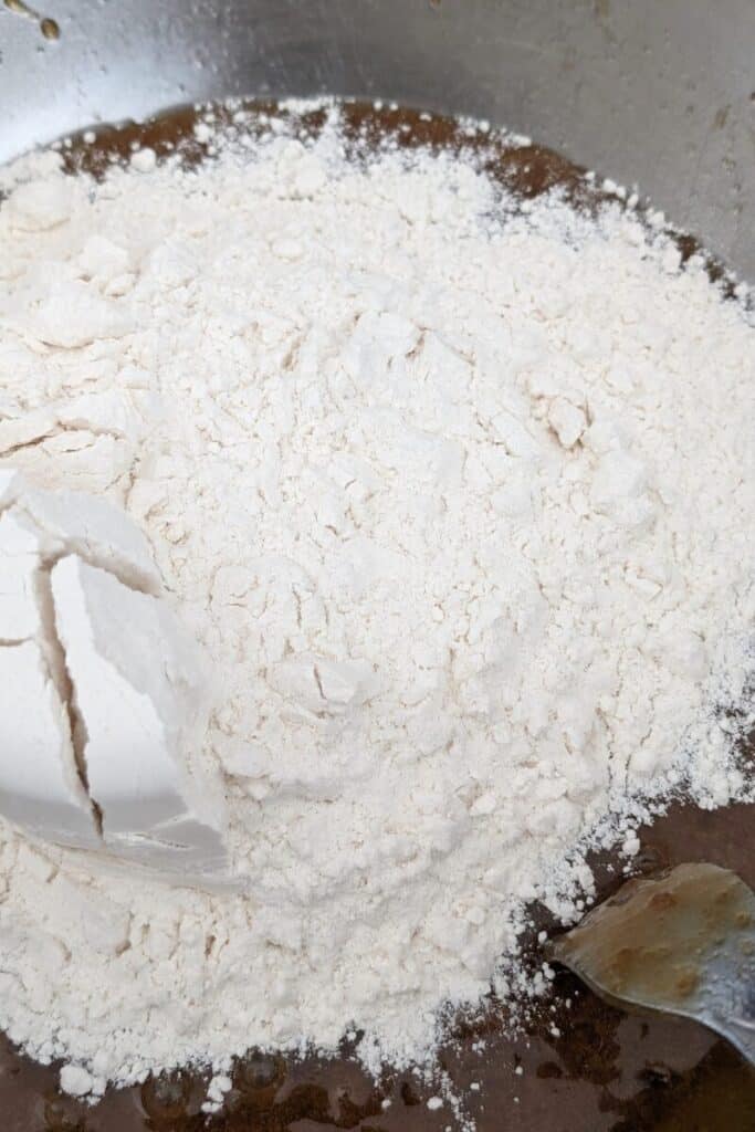 adding flour baking powder salt baking soda to wet cake batter