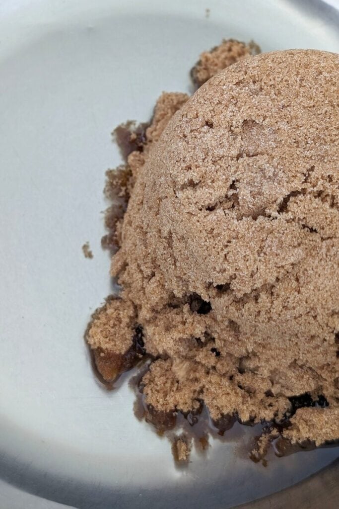 adding oil and brown sugar to bowl
