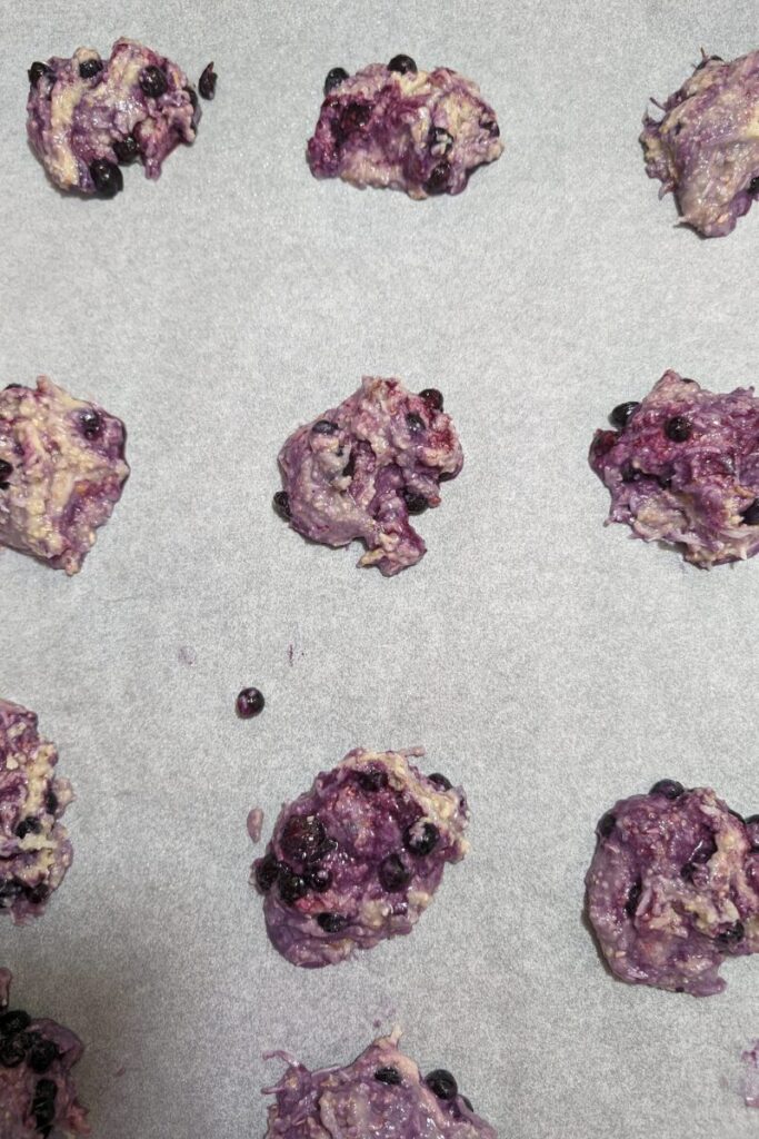 dropping cookie dough onto greased parchment