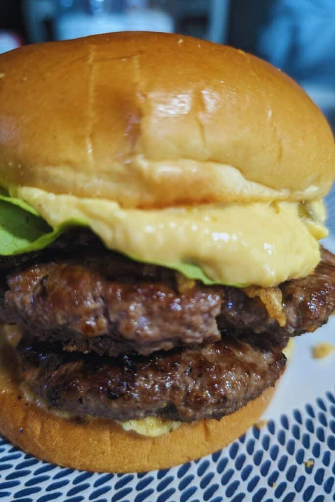 finished burger with con queso sauce