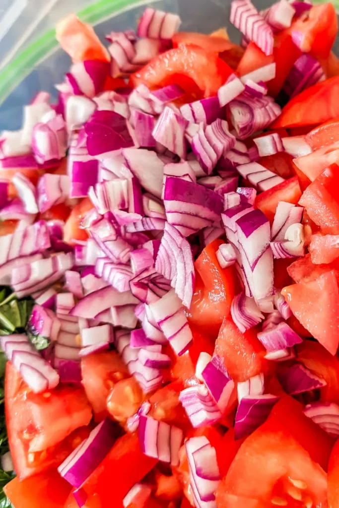 adding red onion to the salad