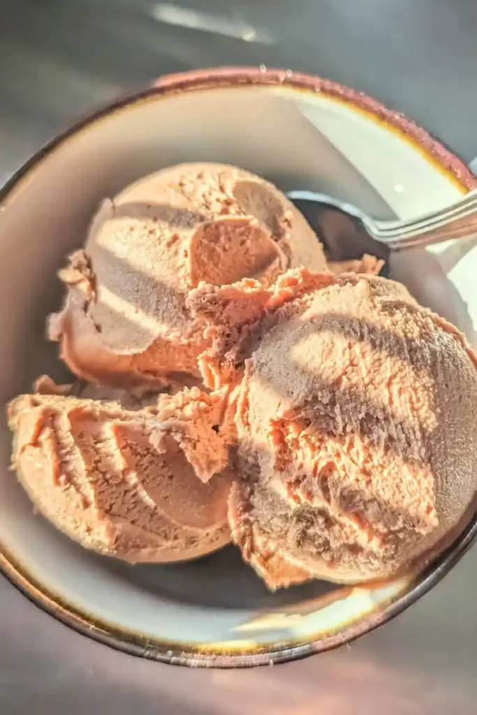 the mocha nutella ice cream scooped into cup with spoon