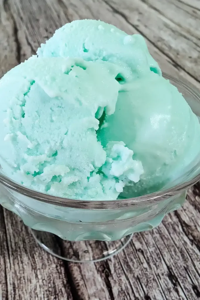 blue raspberry ice cream scoops in glass dish