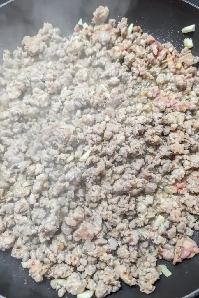 browned ground sausage cooking in pan