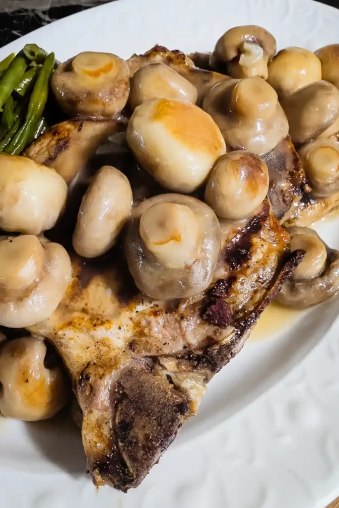 Golden button mushroom sauce over grilled pork chops