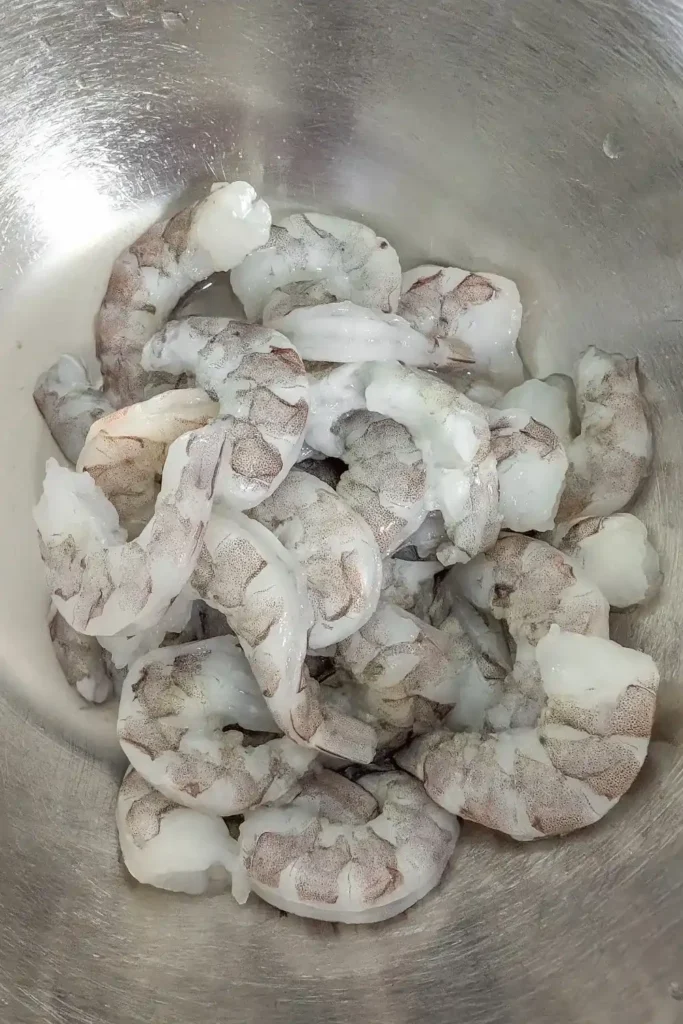 raw shrimp shelled and deviened in stainless steel bowl
