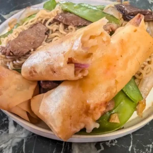 recipe card image of broken shrimp spring roll with another whole