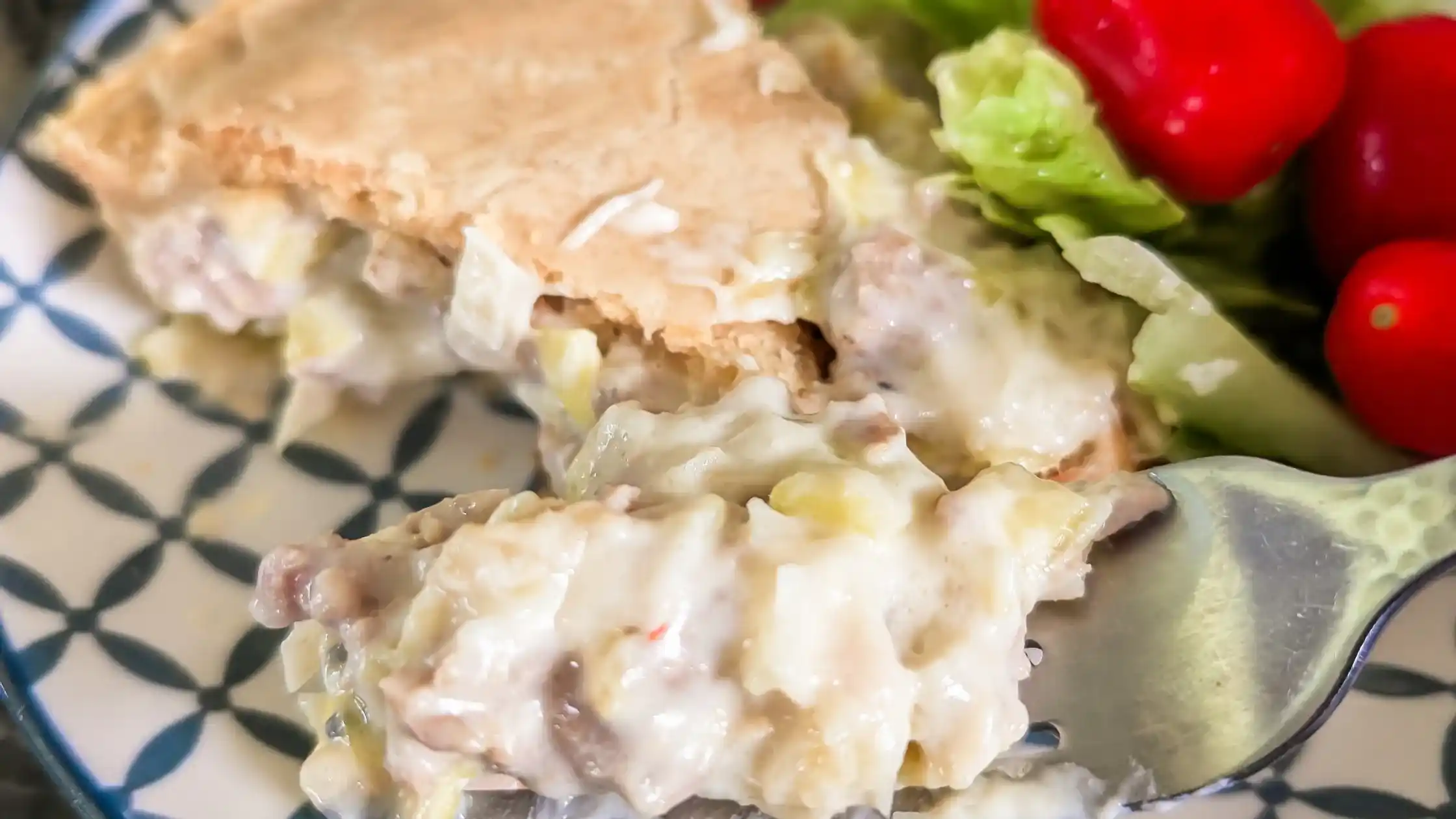 featured image of sliced pie forked with side salad and blue and white plate