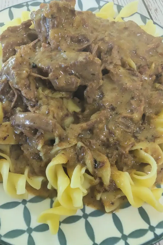 the rich beefy sauce spooned over a plateful of egg noodles