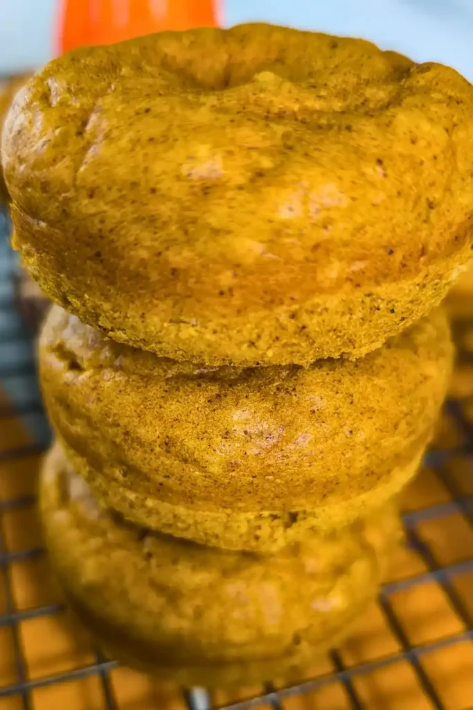 a stack of baked pumpkin donuts