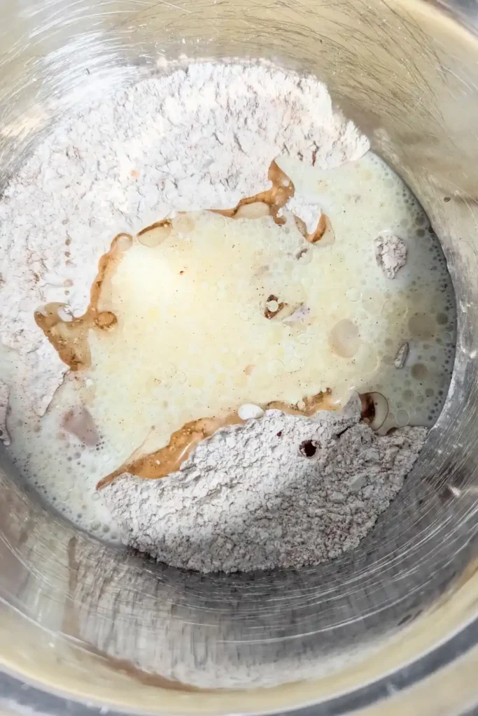 adding buttermilk and oil to donut batter