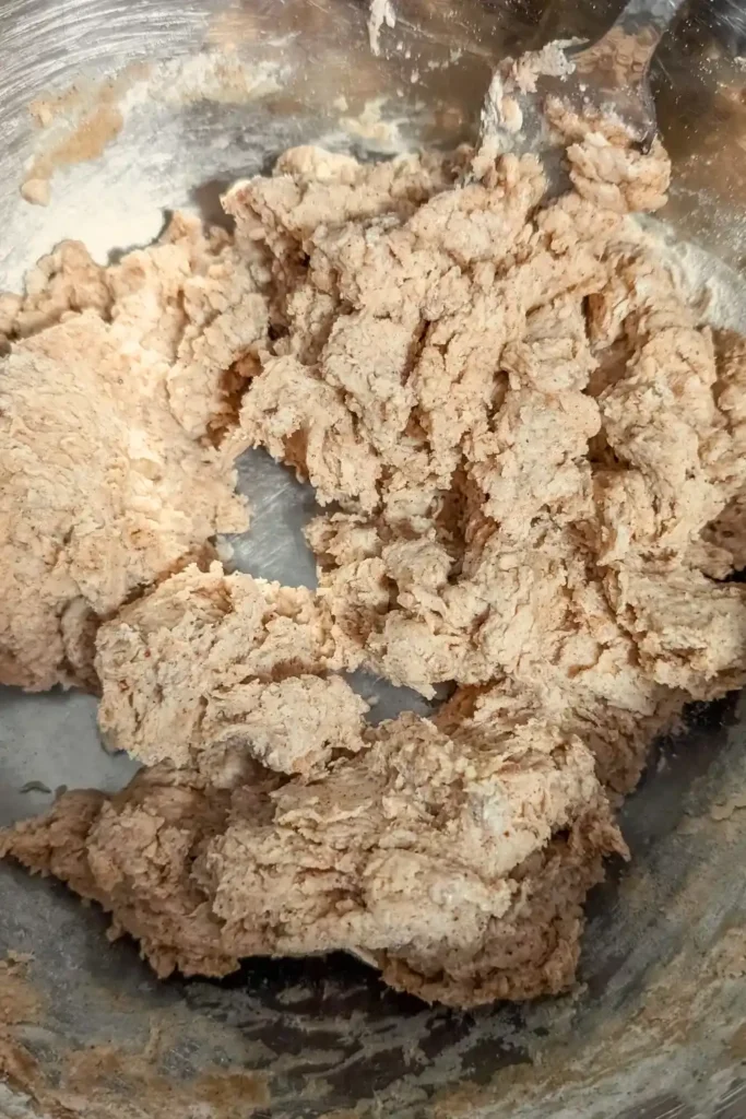 mixed donut batter in stainless steel mixing bowl