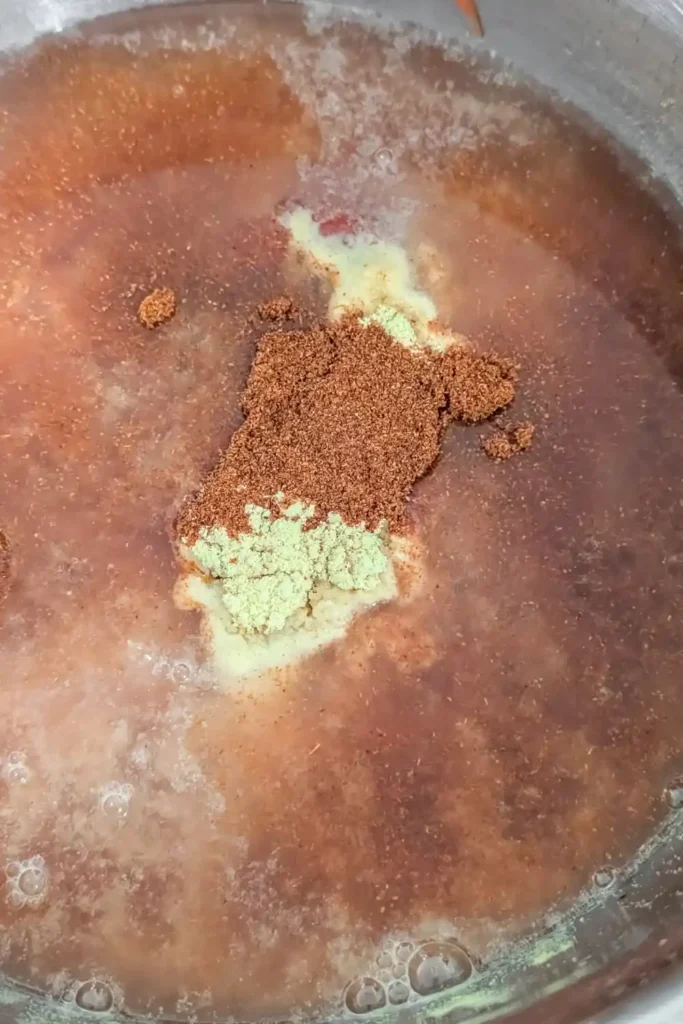 adding chipotle pepper to bbq sauce mixture in bowl