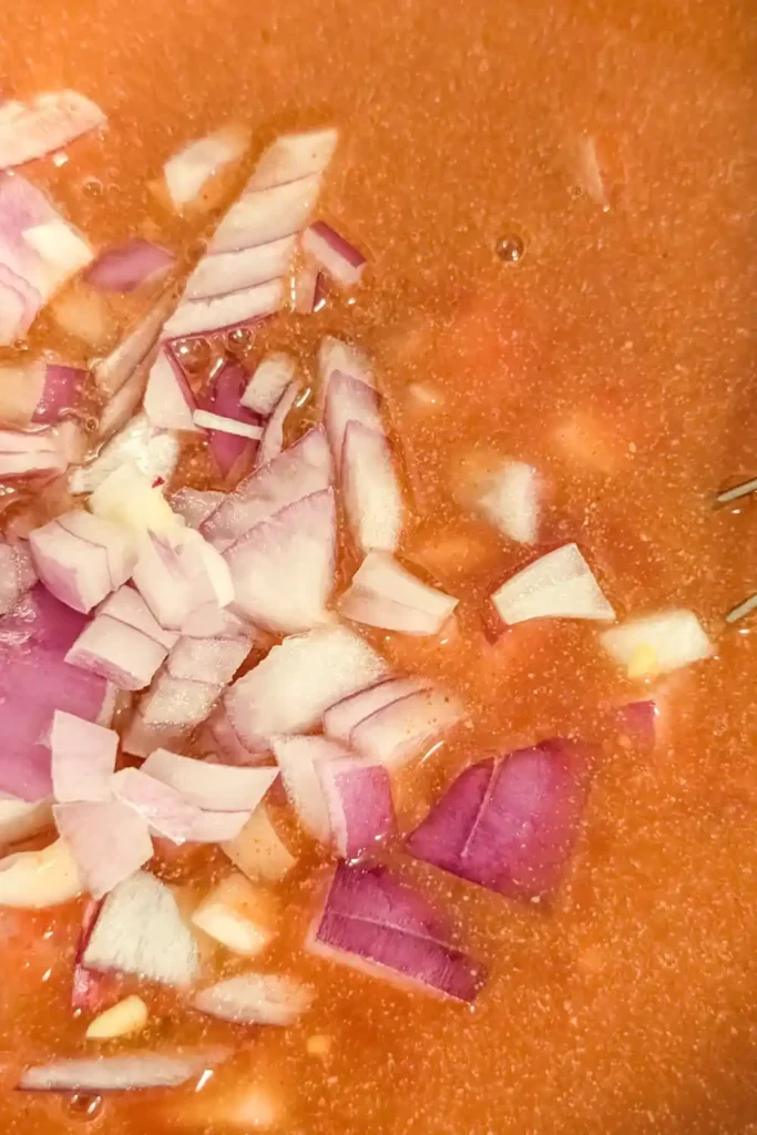 adding diced red onion to bbq sauce mixture