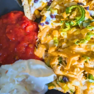 featured image of buffalo chicken nachos with salsa and sour cream