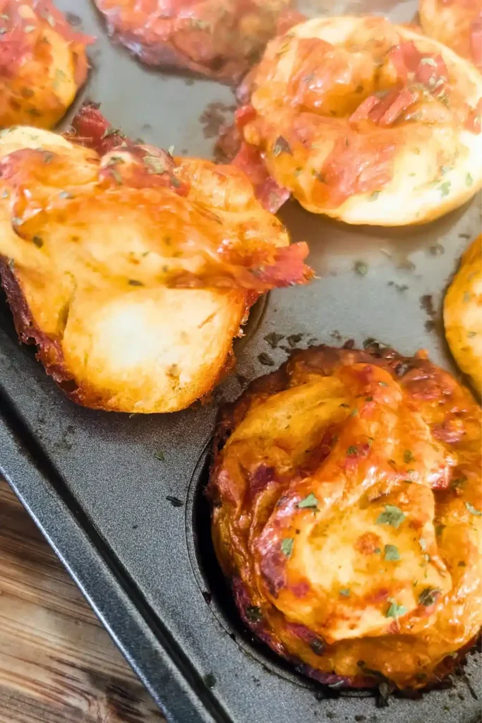 mini pizza muffins close up looking at the bottom of one muffin
