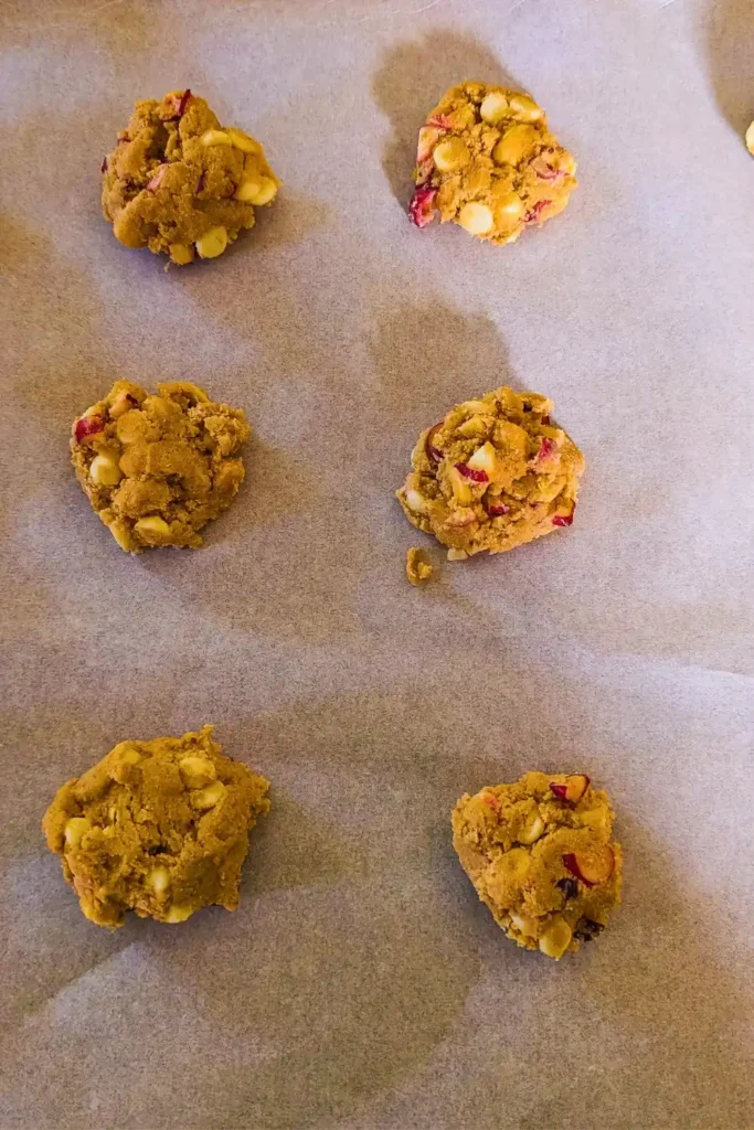 formed cookie dough pucks on parchment paper