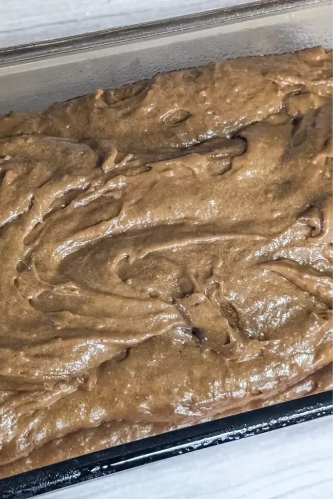 the gingerbread batter in the prepared glass loaf pan