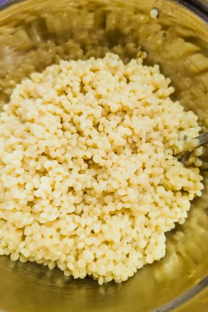 cooked pearl couscous in stainless steel bowl