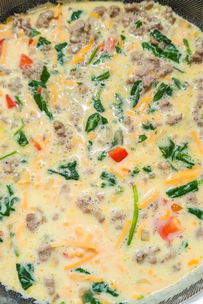 egg mixture with the other ingredients in the frying pan