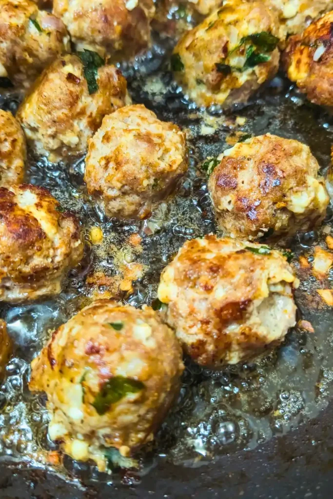 browned meatballs in hot oil