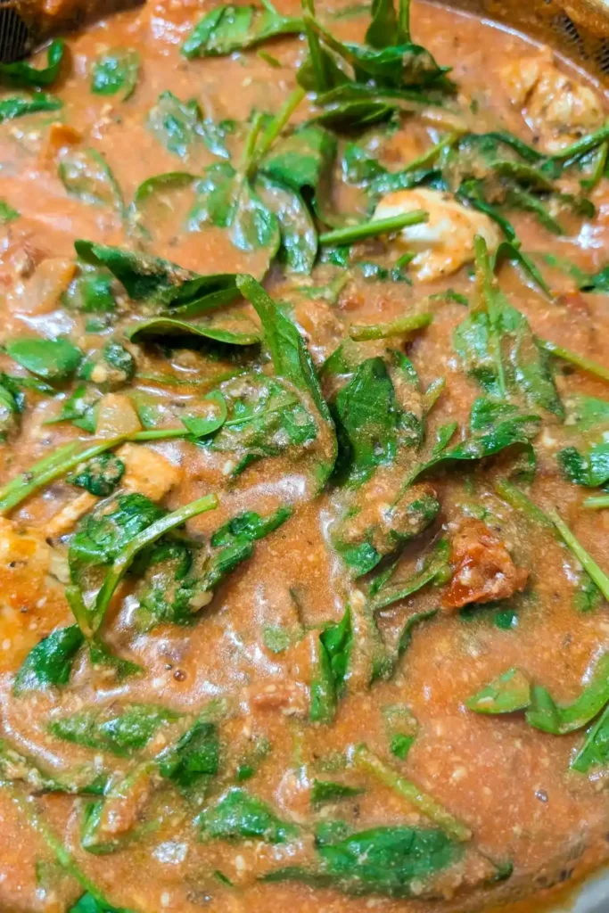 cooking the spinach in the pan