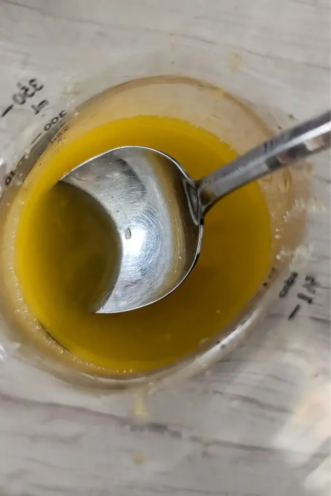 mixing orange juice and sugar for the glaze