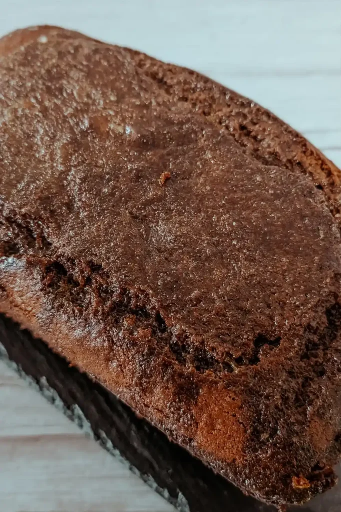 pouring the orange glaze on the gingerbread cake