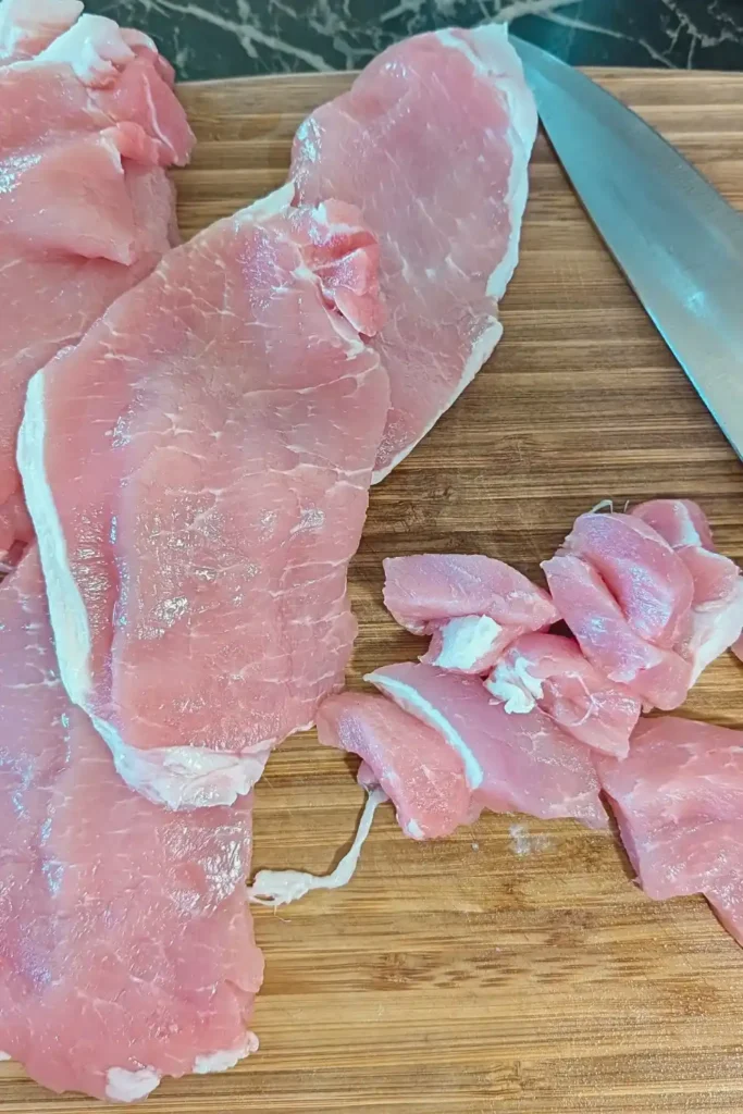 fast fry pork chops on wood cutting board being cut up