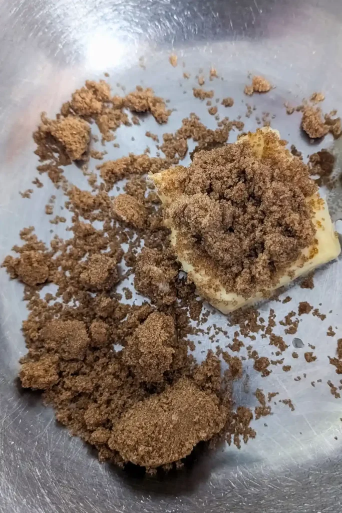 butter and brown sugar in stainless steel mixing bowl