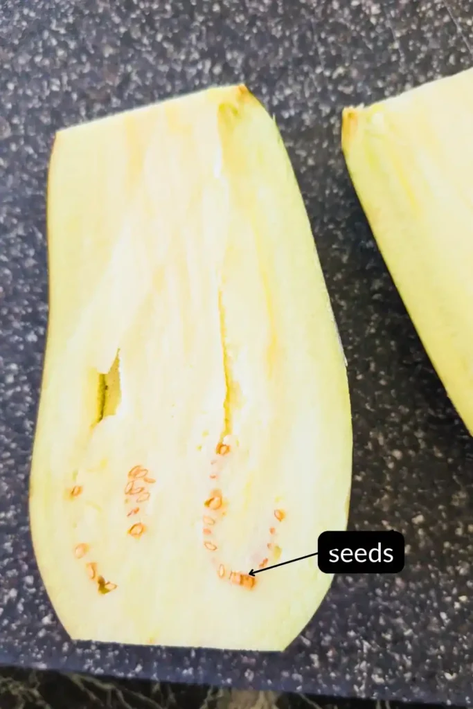 inside cut open eggplant on cutting board