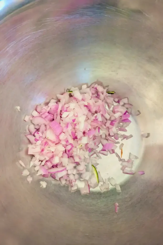 minced onion in stainless steel bowl