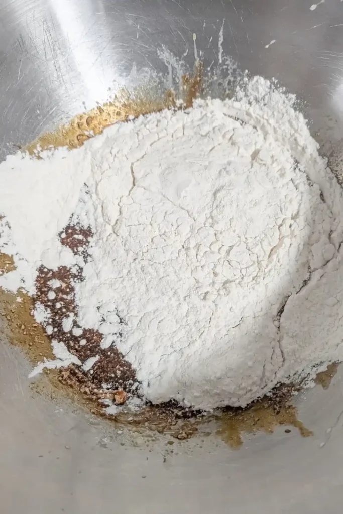 adding flour for the gingerbread batter